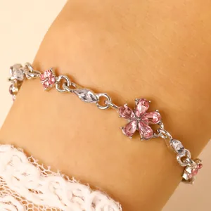 Close-up of silver-tone floral bracelet with pink and white cubic zirconia crystals.