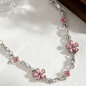 Close-up view of elegant silver bracelet featuring pink crystal flowers and clear zirconia.