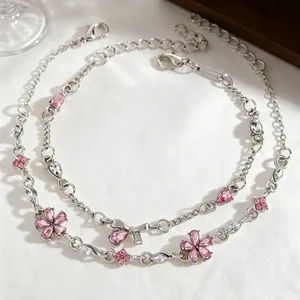 Elegant silver-toned bracelet set featuring pink zircon flower and butterfly bow details