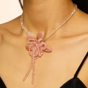 Detailed macro shot of a sweet pink beaded flower necklace with sparkling crystal beads.