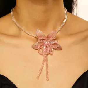Elegant detail shot of a pink dopamine flower beaded necklace worn by a female model