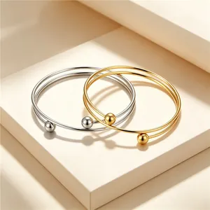 Elegant minimalist stainless steel double-loop bangles in gold and silver finishes