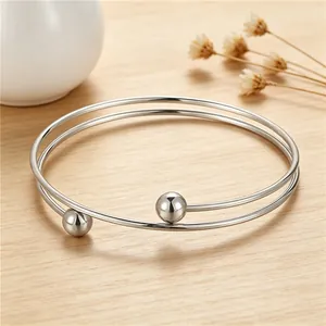 High-polished stainless steel double-loop bangle bracelet featuring elegant spherical beads