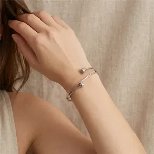 Minimalist silver stainless steel double-strand cuff bracelet with ball beads worn on wrist