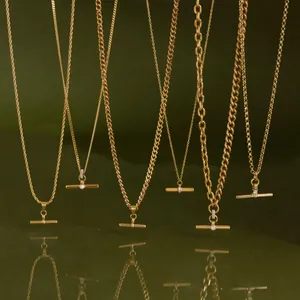 Multiple gold stainless steel T-bar necklaces showing various chain textures and detail