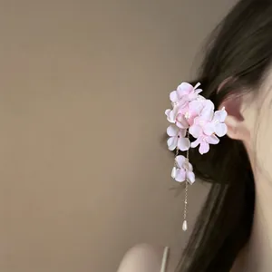Elegant pink fabric flower hair clip featuring pearl tassels and a delicate gold chain.