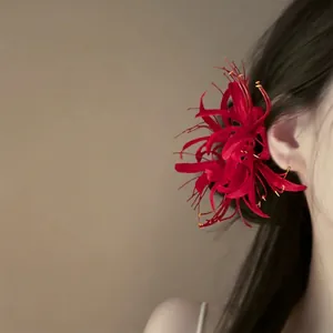 Elegant red fabric spider lily flower hair clip accessory for back of head bun styles