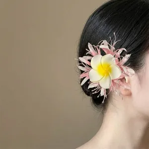 Elegant white and pink cloth plumeria flower hair clip accessory for elegant bun hairstyles