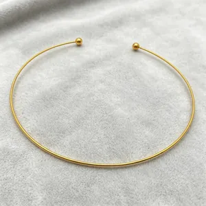 Detailed view of a minimalist gold stainless steel C-shaped open choker necklace