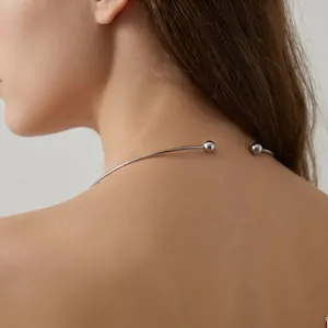 Detailed view of a minimalist silver titanium steel C-shaped open torque necklace