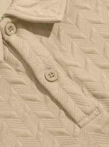 Macro detail of breathable jacquard knit texture and buttons on beige men's polo shirt