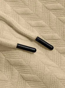 Close-up of jacquard fabric and drawstring on men's leisure polo shorts set.