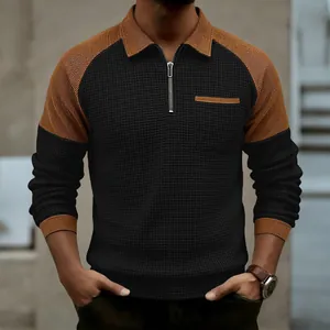Detailed view of men's waffle knit half-zip polo shirt in black and ginger brown