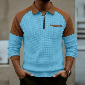Detailed view of men's waffle knit polo shirt with blue body and brown contrast sleeves