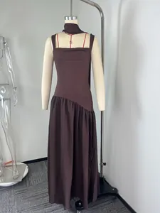 Detail view of a brown sleeveless casual maxi dress displayed on a mannequin in a studio