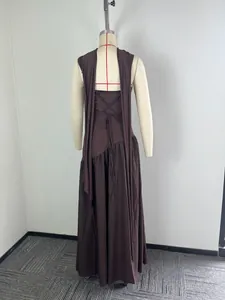 Back view of a dark brown maxi dress featuring an elegant lace-up tie design on a mannequin