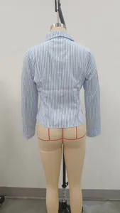 Back view detail of a stylish light blue and white vertical striped long-sleeved shirt.