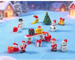 Macro detail of festive Christmas resin miniatures arranged on blue textured snow