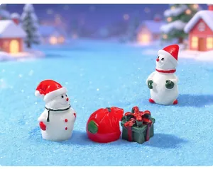Detailed macro view of miniature Christmas resin snowman and gift box figurines