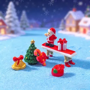 Set of miniature Christmas resin figurines including Santa Claus and Xmas tree