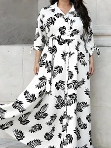 Elegant plus size white maxi shirt dress with black leaf print and a waist belt