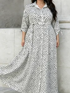 Full length view of a stylish plus size floral print shirt maxi dress with waist belt.