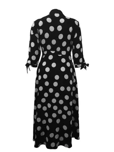 Back view of a black and white polka dot print plus size shirt dress with bow cuffs.