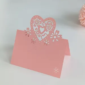 Macro view of an elegant pink laser-cut heart place card for wedding party tables