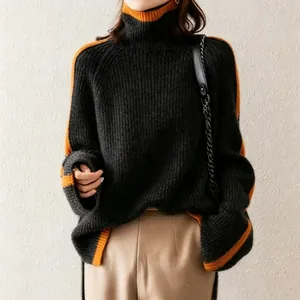 Elegant oversized women's turtleneck knit sweater in retro black and orange contrast design