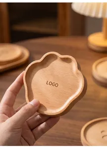 Detailed view of a bear paw shaped beech wood coaster with natural grain finish