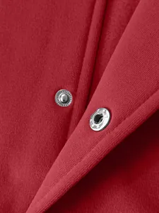 Macro detail of high-quality silver metal snap buttons on heavy red fleece sports jacket