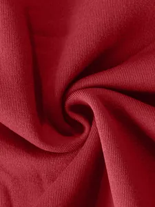 Macro close-up detail showing the texture of heavyweight red ribbed sports jacket fabric