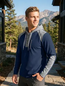 Detail of men's waffle knit hoodie with lace-up neck and color blocking design