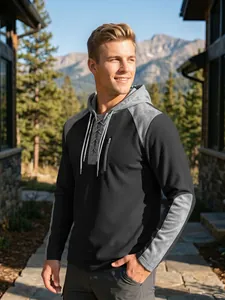Detail of men's waffle knit hoodie featuring lace-up front and grey color-block sleeves