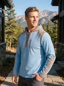 Detail of men's waffle knit drawstring hoodie with contrast patchwork sleeves