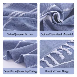 High-quality blue and white striped cotton beach towel with decorative tassel fringes close-up