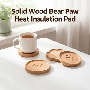 Close-up of beech wood coaster with cute bear paw pattern on white table