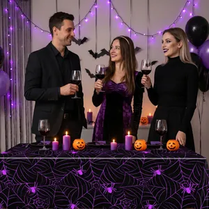 Atmospheric Halloween party scene featuring a purple spider web tablecloth for decor