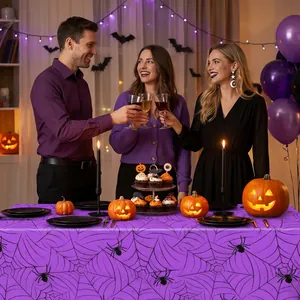 Purple spider web tablecloth shown in a festive Halloween party setting with decorations