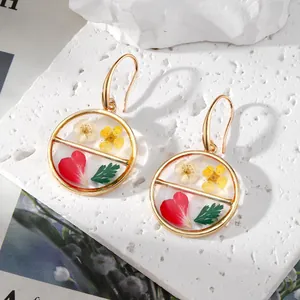 Handmade gold round resin earrings with real dried forget-me-not and daisy flowers