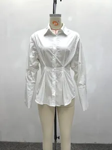 Detailed front view of a white pleated waist long-sleeve women's shirt on mannequin