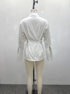 Detailed back view of a minimalist white pleated waist shirt for women with long sleeves