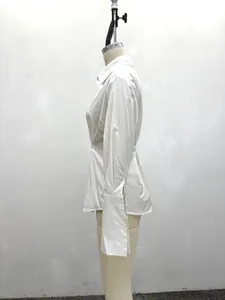 Side profile of a minimalist white long-sleeved shirt with pleated waist design.