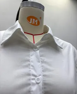 Detailed close-up view of a white minimalist button-down shirt collar and placket