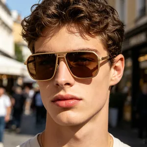 Close-up detail of men's square gold metal frame sunglasses with tinted lenses on a male model