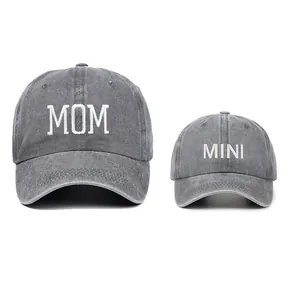 Detail of grey parent-child washed cotton baseball caps with MOM and MINI embroidery