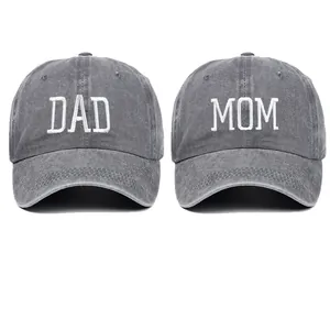 Detailed view of DAD and MOM white embroidery on grey washed cotton baseball caps