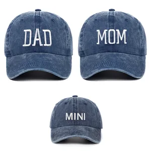 Macro view of DAD MOM MINI embroidery on washed cotton baseball caps for parent-child set