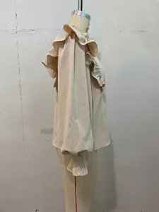 Detailed side view of elegant cream-colored ruffle long sleeve blouse on professional mannequin