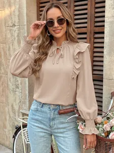 Elegant beige ruffled long sleeve blouse featuring tie neck and elastic cuffs detail